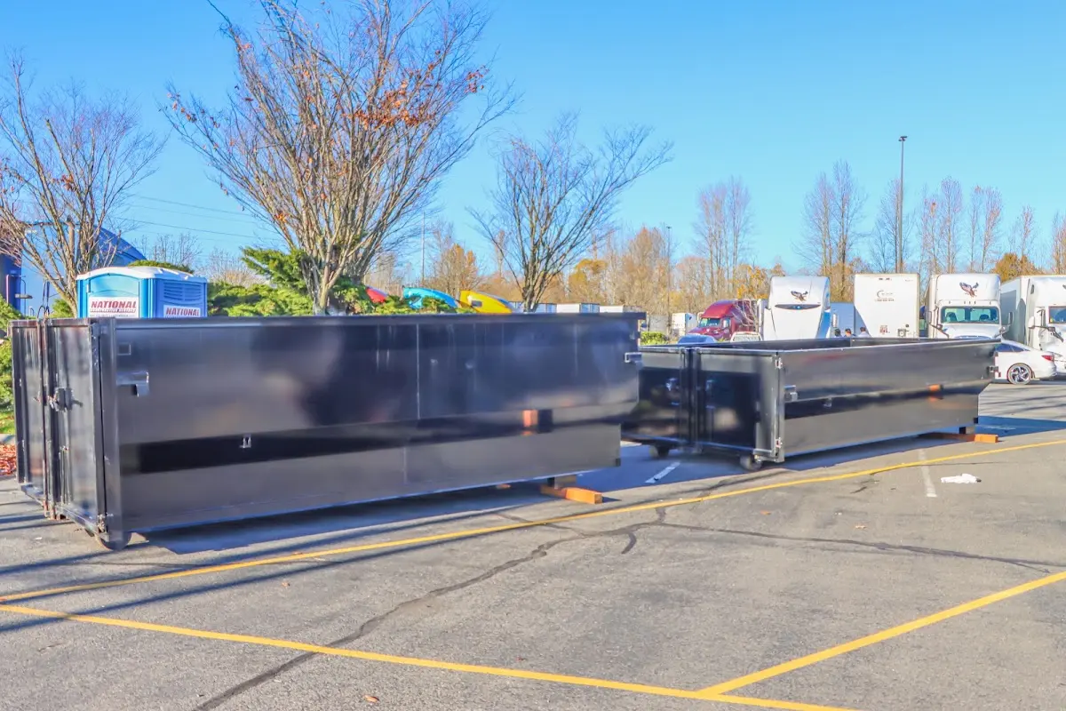 Professional dumpster rental service with roll-off container on residential driveway in Sleepy Hollow